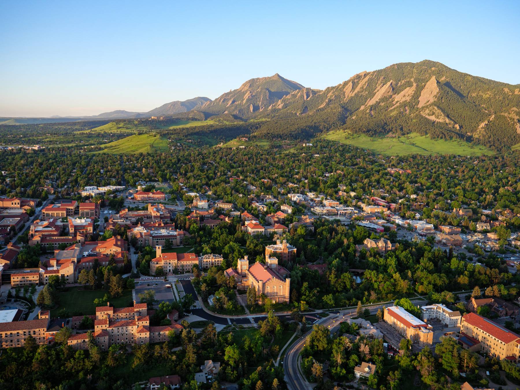 ASCENT researchers collaborating around a conference table overlooking the Boulder Flatirons.